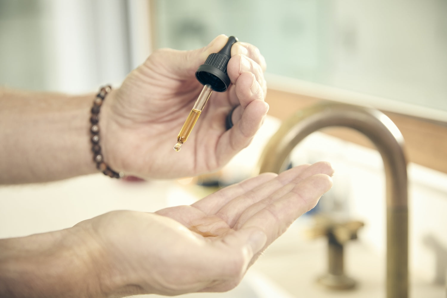 Cleansing oil dropping into hands